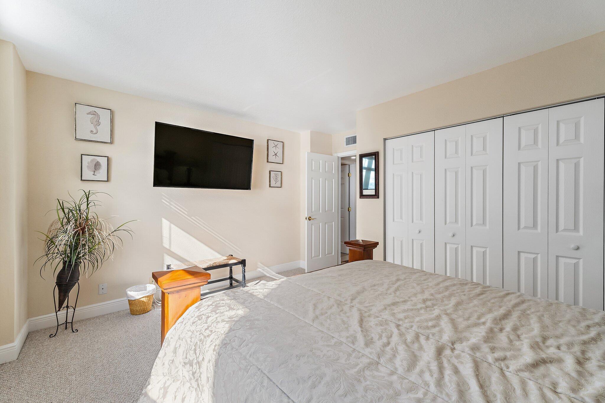 Undisclosed Address Singer Island, FL 33404 - Photo 32 of 77 a bedroom with a bed and a flat screen tv