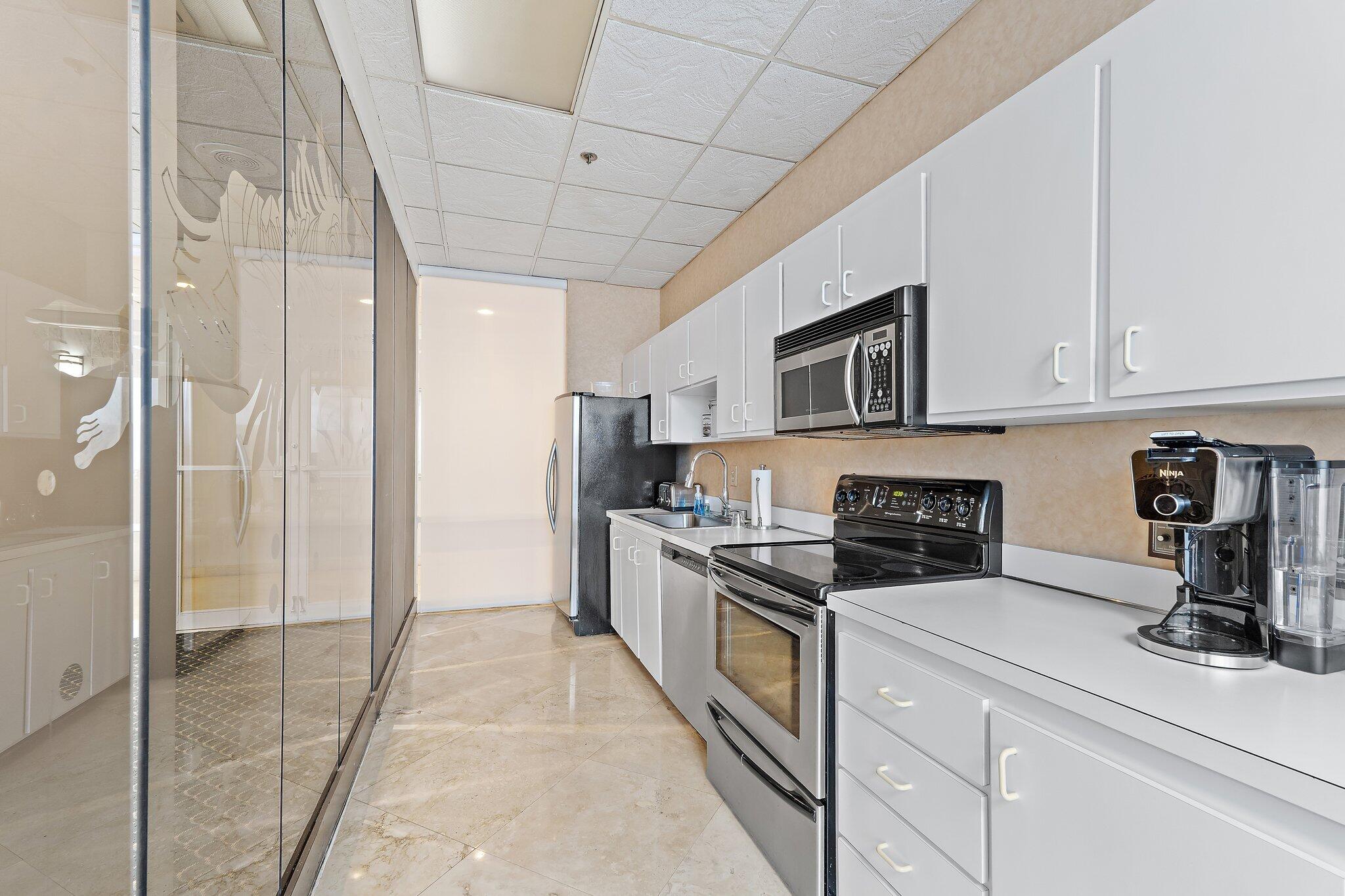Undisclosed Address Singer Island, FL 33404 - Photo 46 of 77 a kitchen with stainless steel appliances granite countertop a stove a sink and a refrigerator