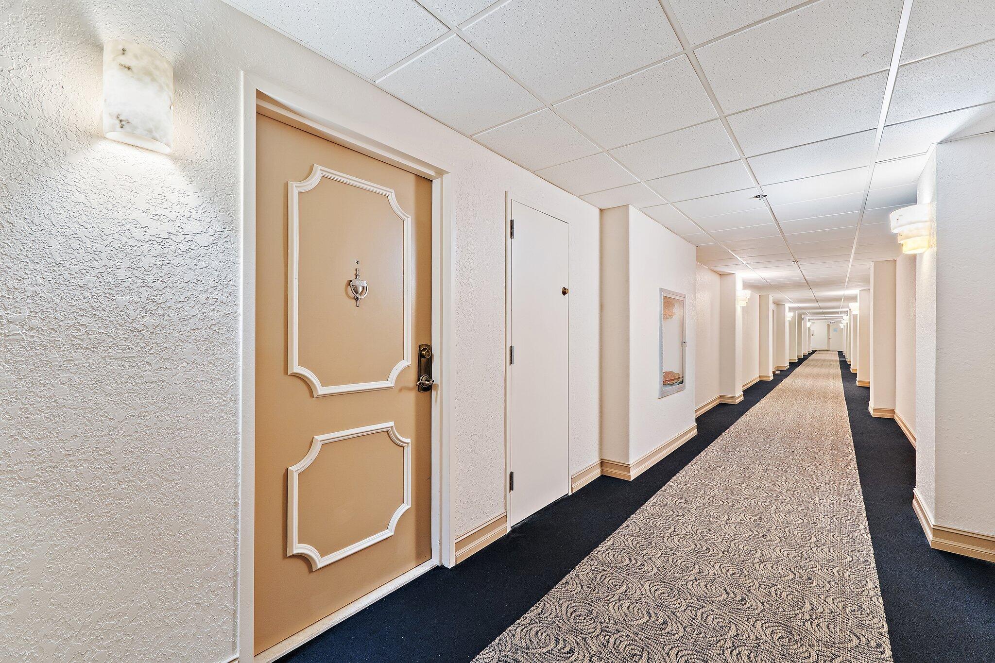 Undisclosed Address Singer Island, FL 33404 - Photo 50 of 77 a hallway with sliding door and wooden floor
