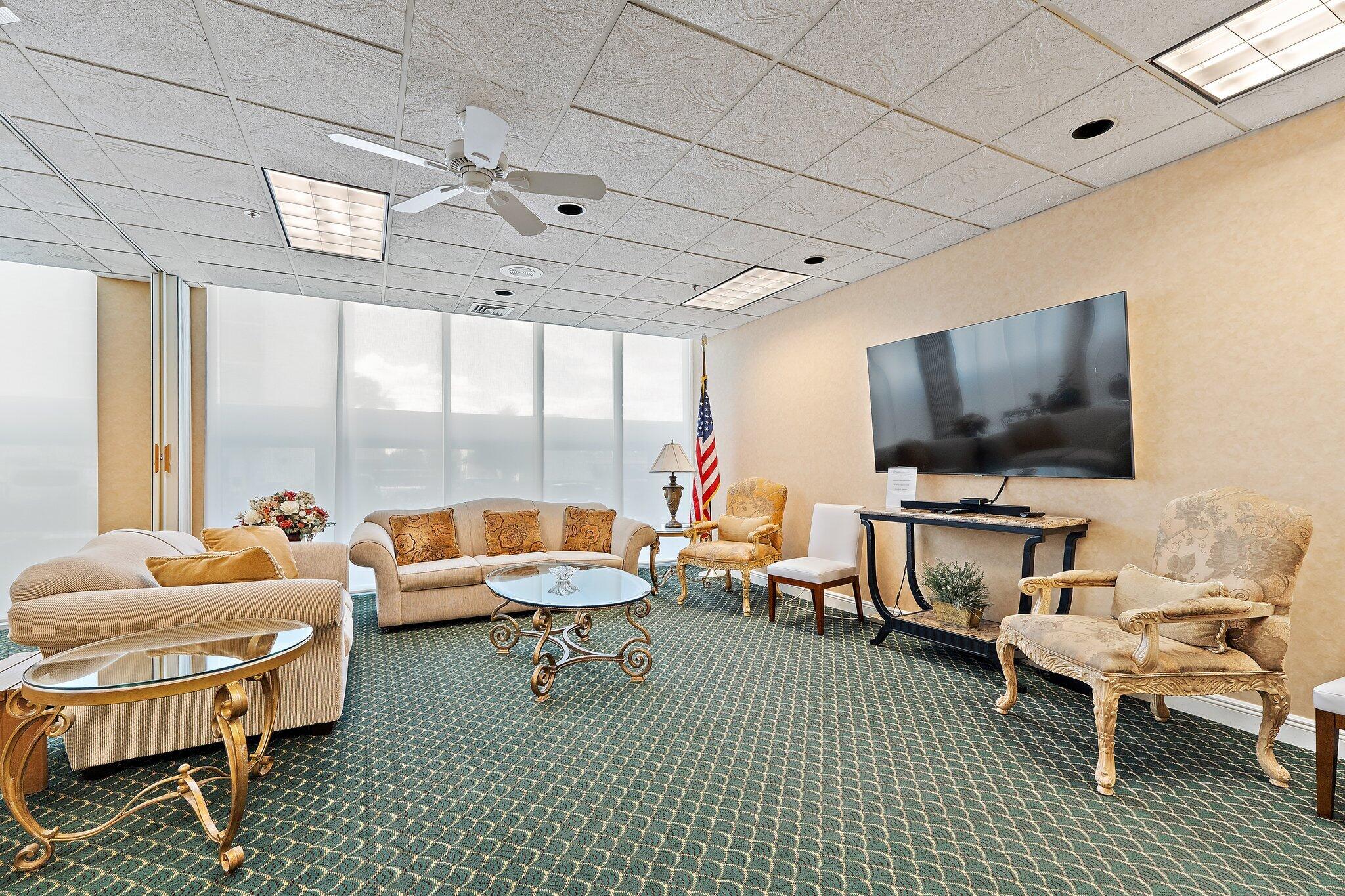 Undisclosed Address Singer Island, FL 33404 - Photo 53 of 77 a living room with furniture a flat screen tv and a large window
