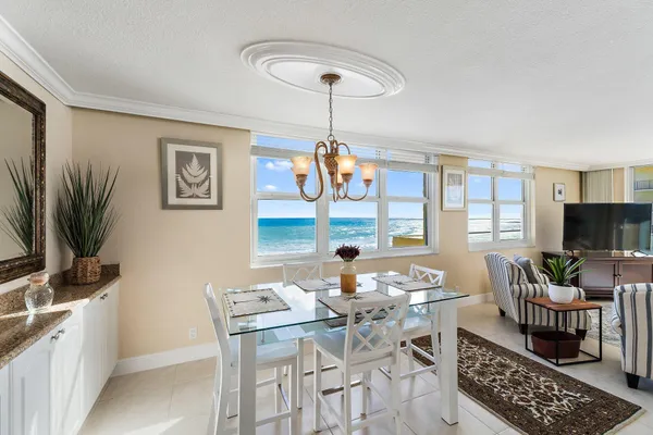 a living room with furniture a flat screen tv and a large window
