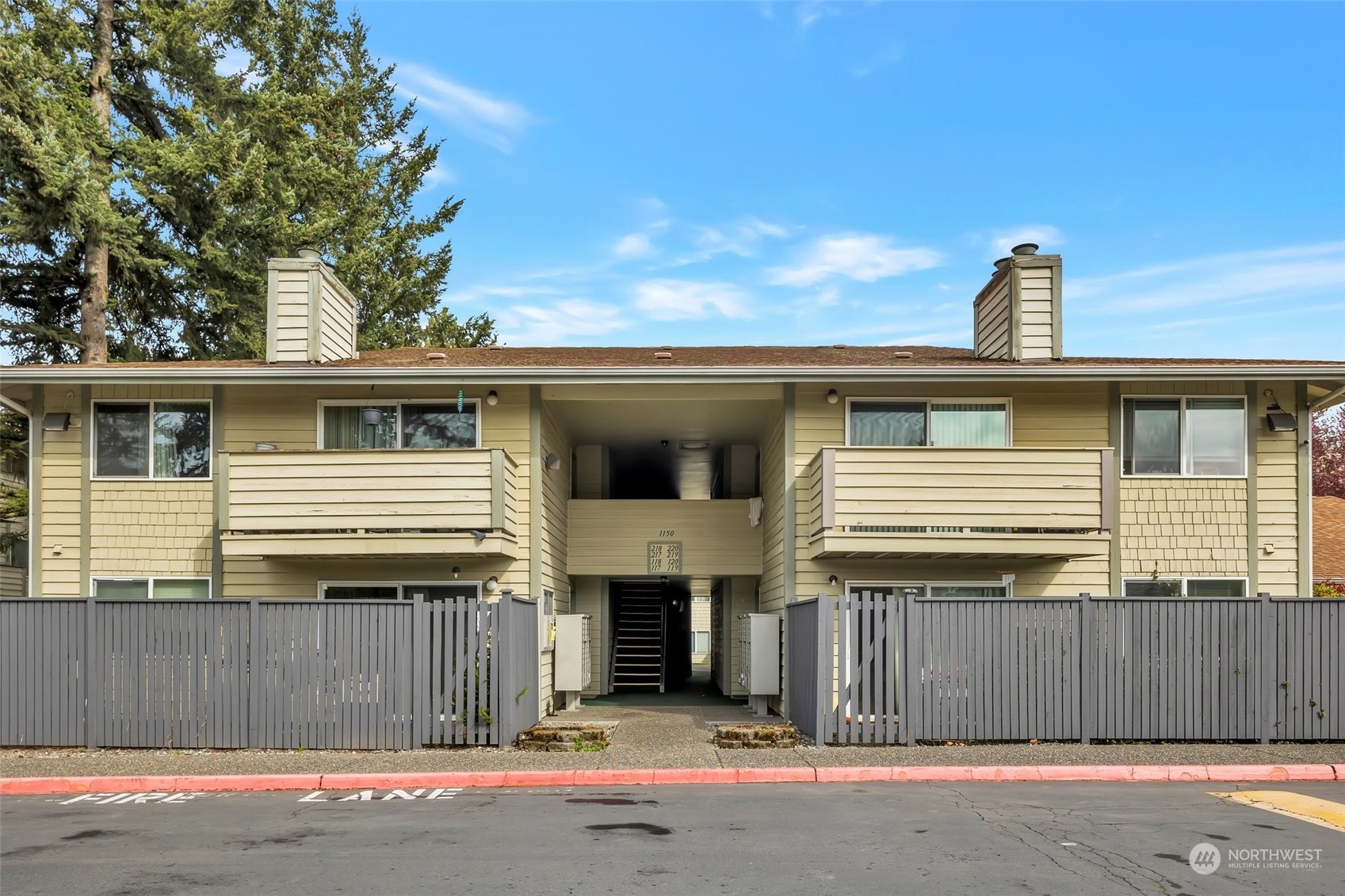 1150 Sunset Boulevard Northeast, Unit 118 Renton, WA 98056 - Photo 2 of 12 a front view of a house with a garage