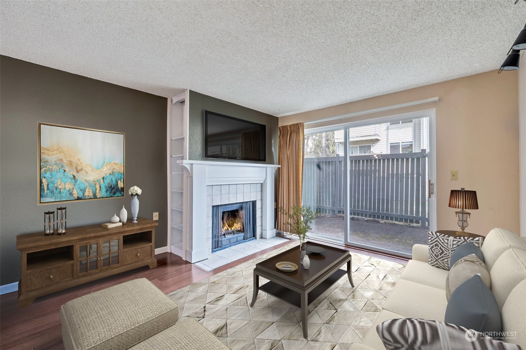 1150 Sunset Boulevard Northeast, Unit 118 Renton, WA 98056 - Photo 3 of 12 a living room with furniture a flat screen tv and a fireplace