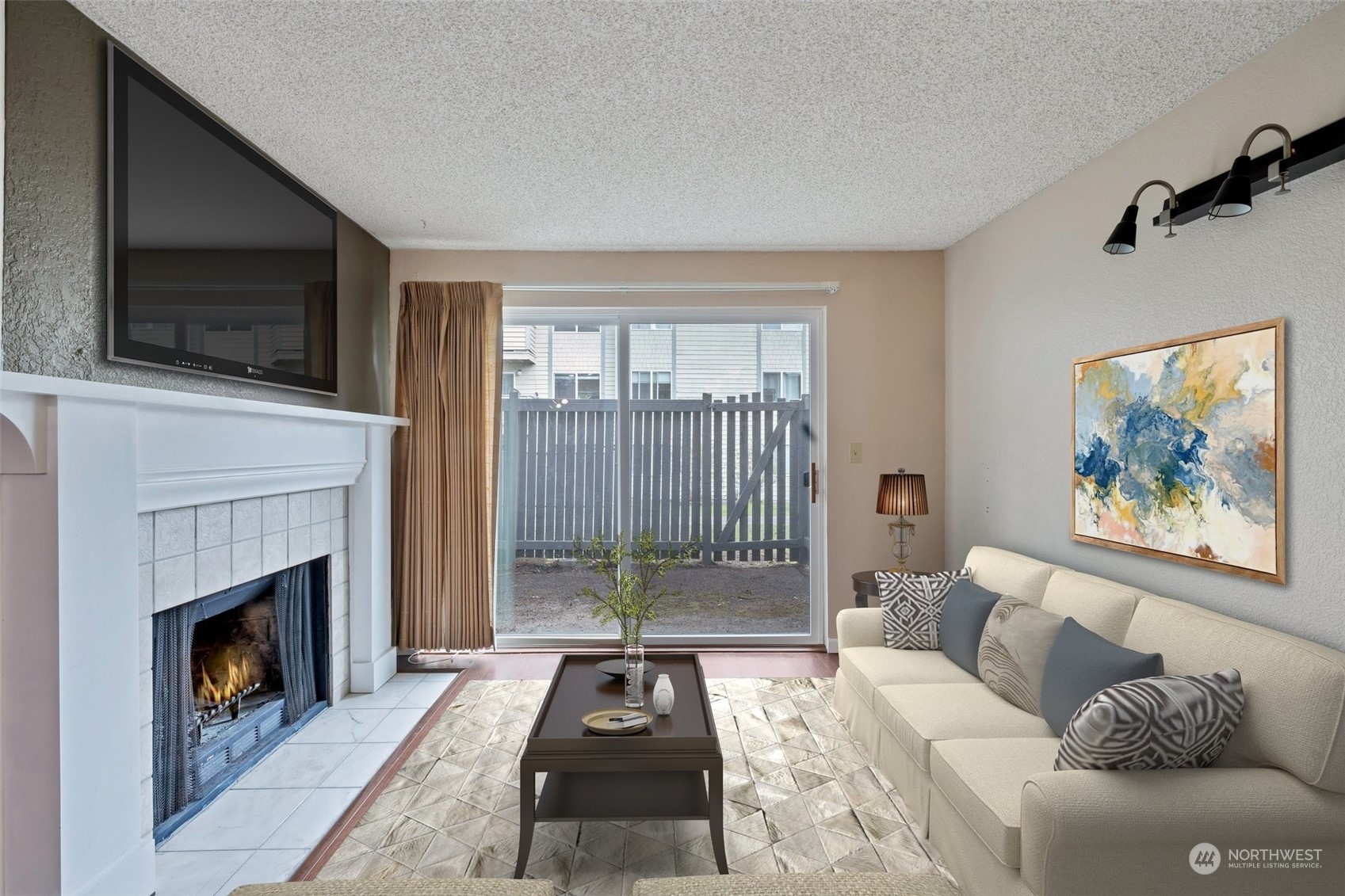 1150 Sunset Boulevard Northeast, Unit 118 Renton, WA 98056 - Photo 4 of 12 a living room with furniture a flat screen tv and a fireplace