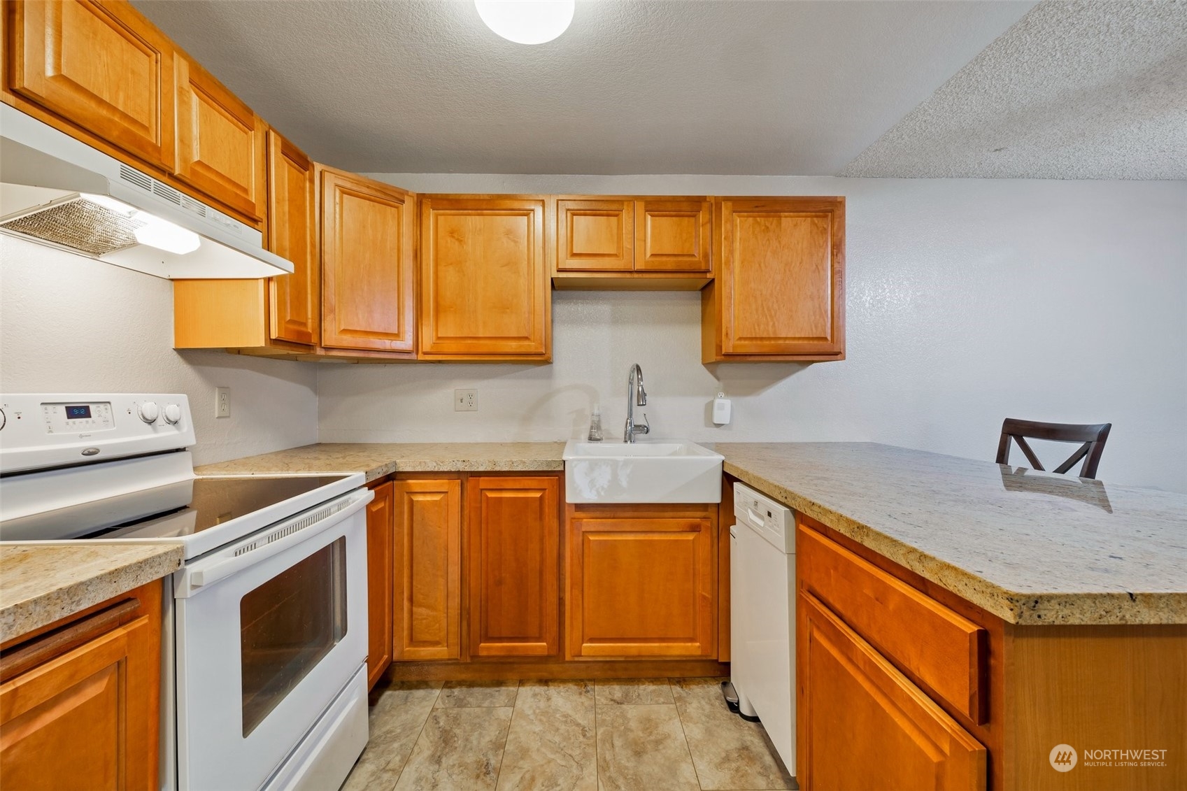 1150 Sunset Boulevard Northeast, Unit 118 Renton, WA 98056 - Photo 5 of 12 a kitchen with granite countertop cabinets stainless steel appliances and a sink