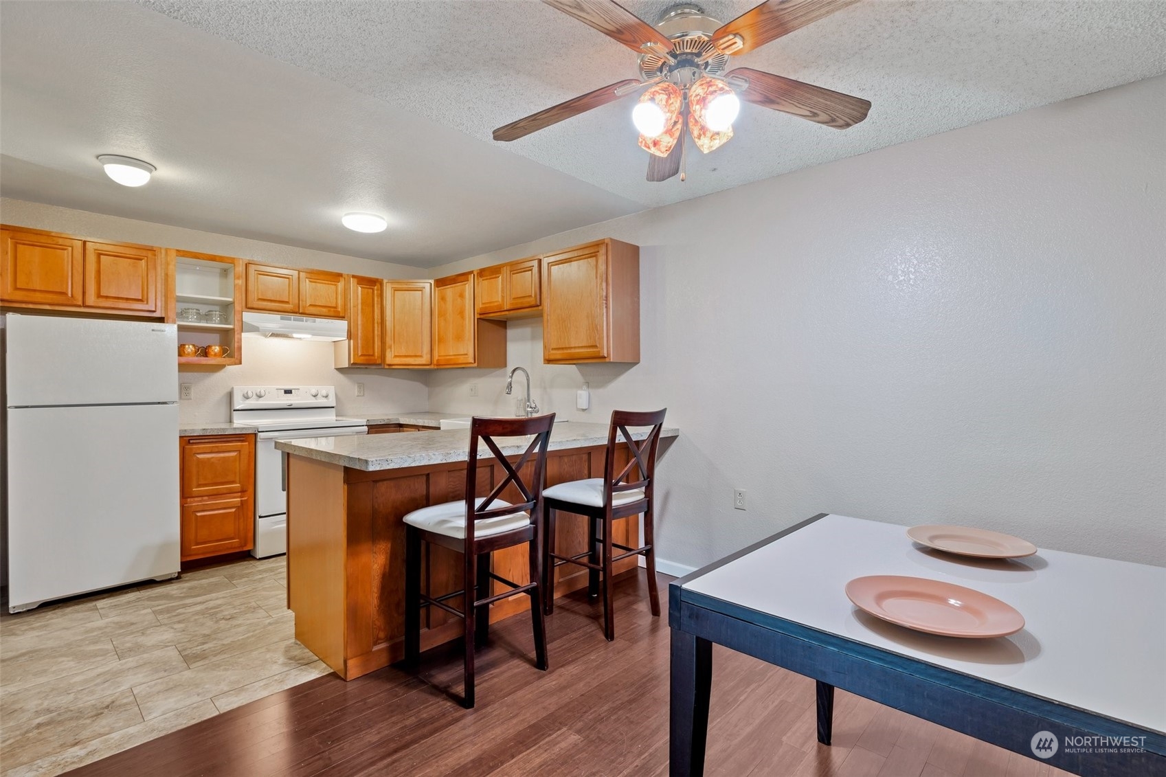 1150 Sunset Boulevard Northeast, Unit 118 Renton, WA 98056 - Photo 6 of 12 a view of kitchen with cabinets and wooden floor