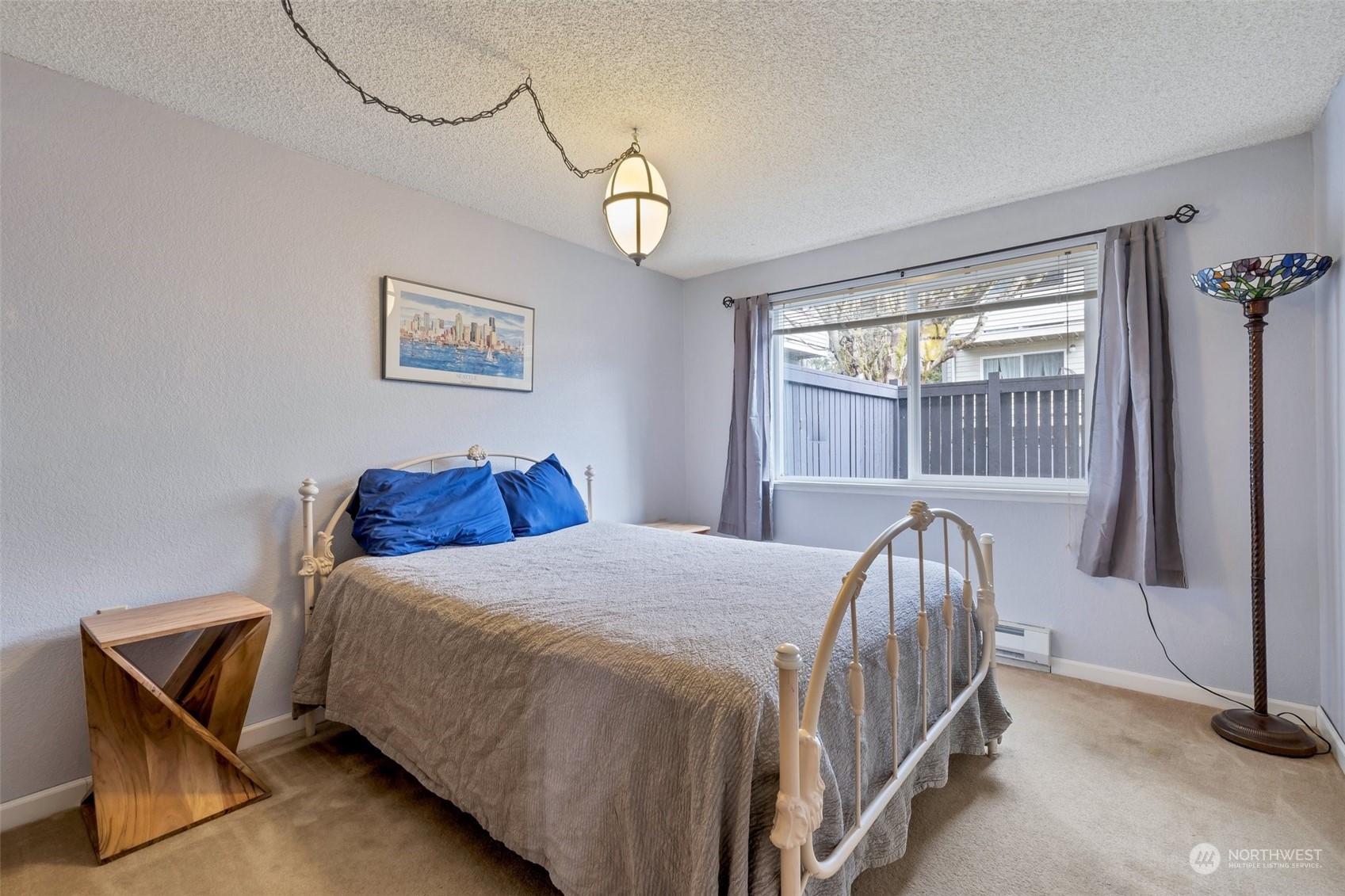 1150 Sunset Boulevard Northeast, Unit 118 Renton, WA 98056 - Photo 8 of 12 a bedroom with a bed and a window