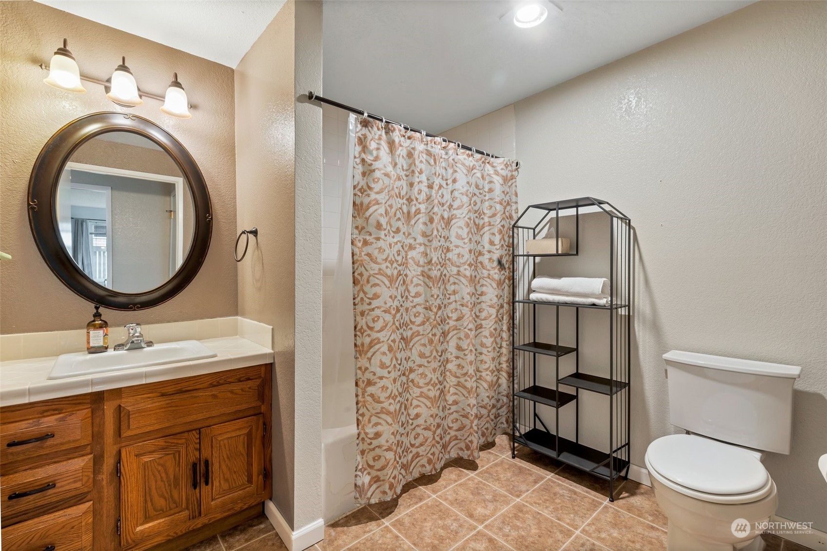 1150 Sunset Boulevard Northeast, Unit 118 Renton, WA 98056 - Photo 9 of 12 a bathroom with a sink a toilet and a mirror