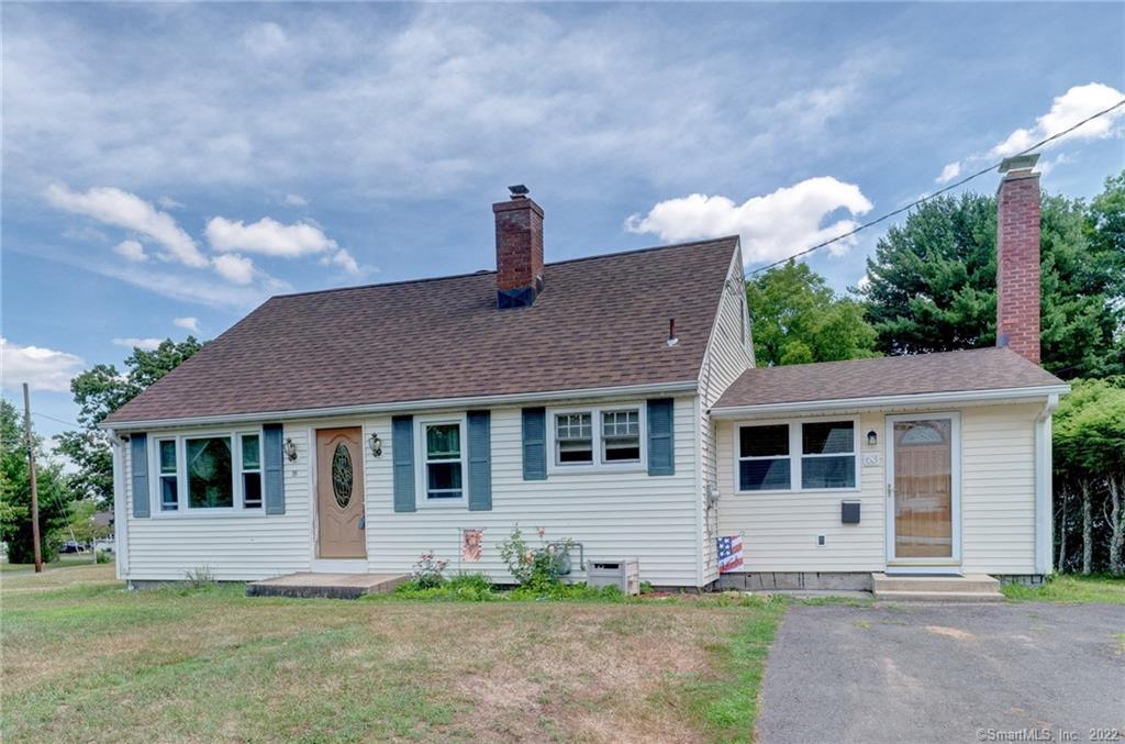 a front view of a house with a garden and yard