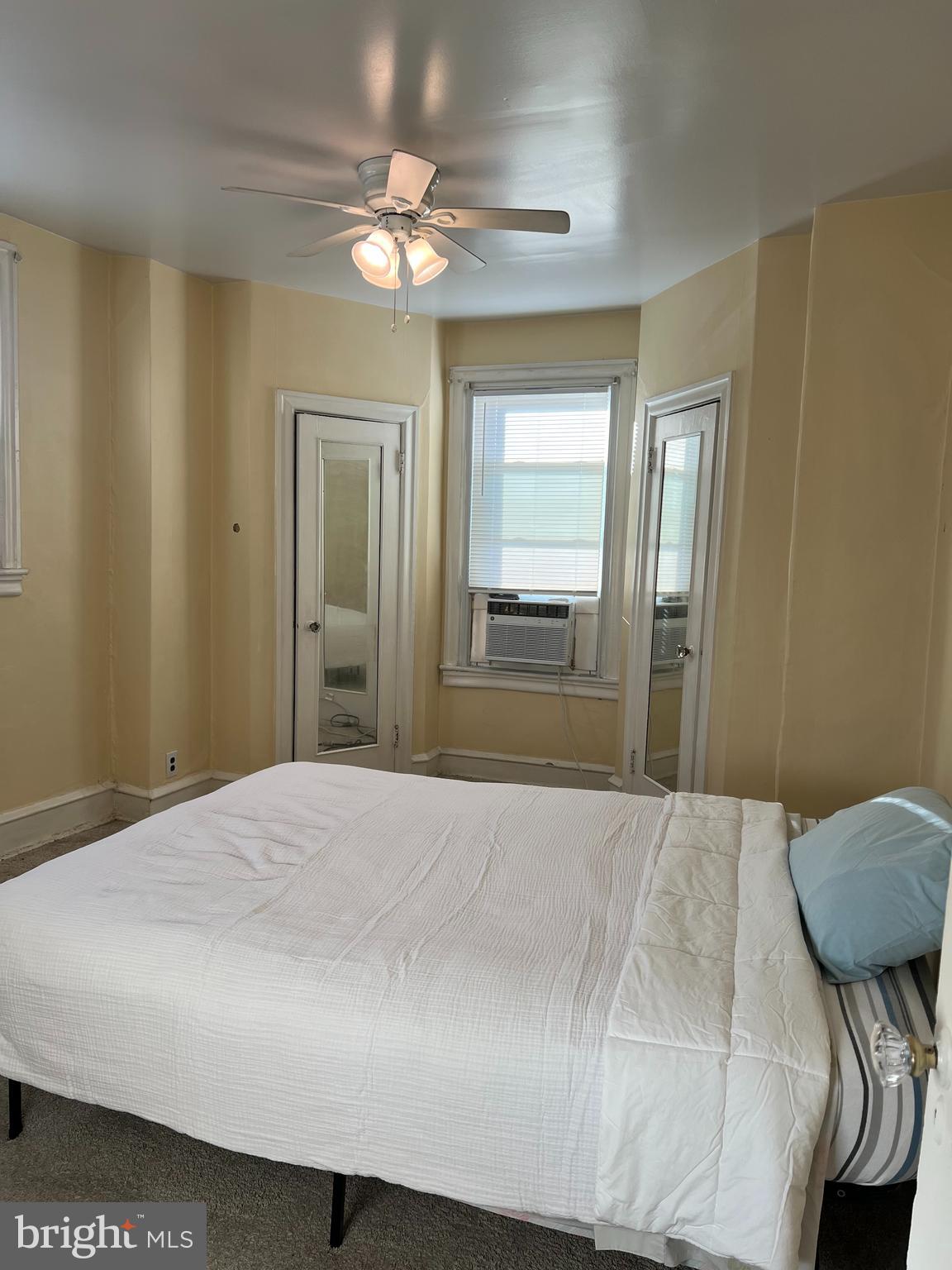 1630 Conlyn Street, Unit 2 Philadelphia, PA 19141 - Photo 5 of 10 a bedroom with a bed and a chandelier