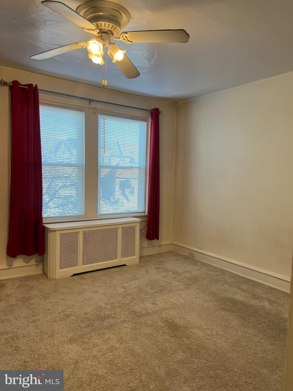 1630 Conlyn Street, Unit 2 Philadelphia, PA 19141 - Photo 7 of 10 an empty room with windows and fan