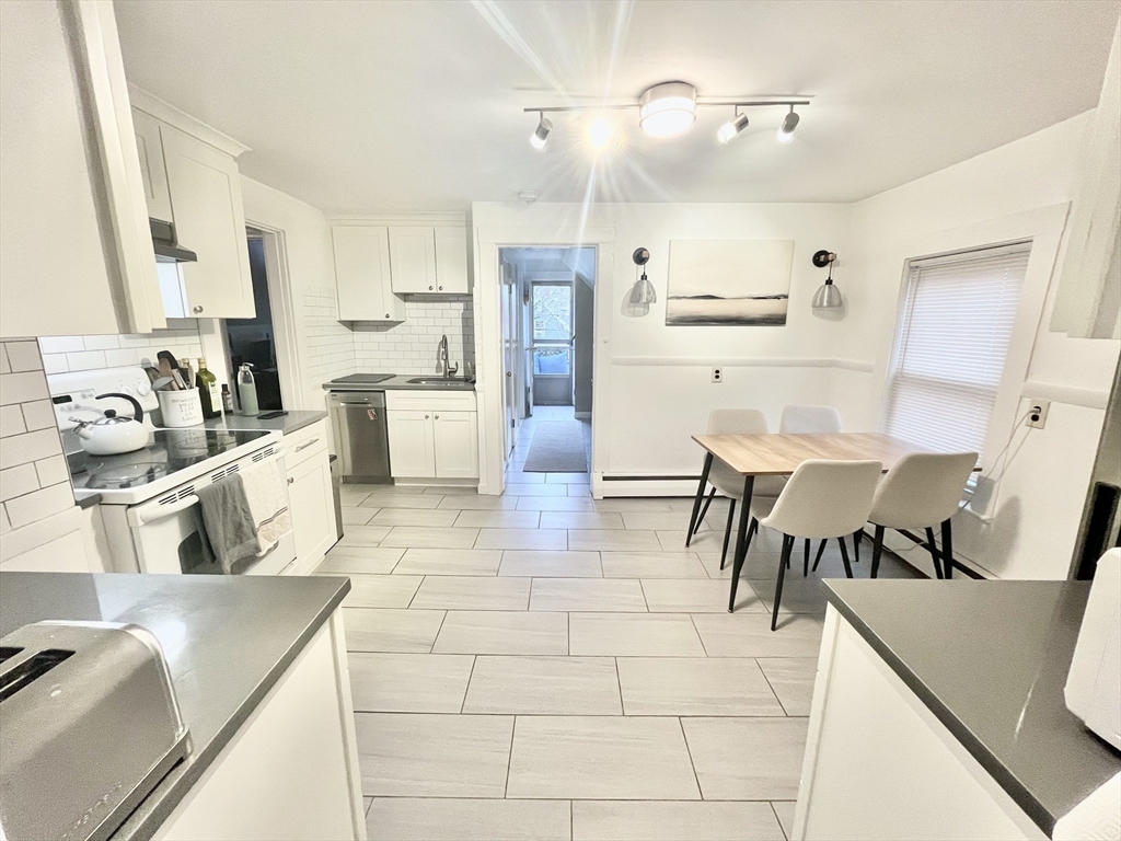 a kitchen with stainless steel appliances kitchen island granite countertop a sink and cabinets