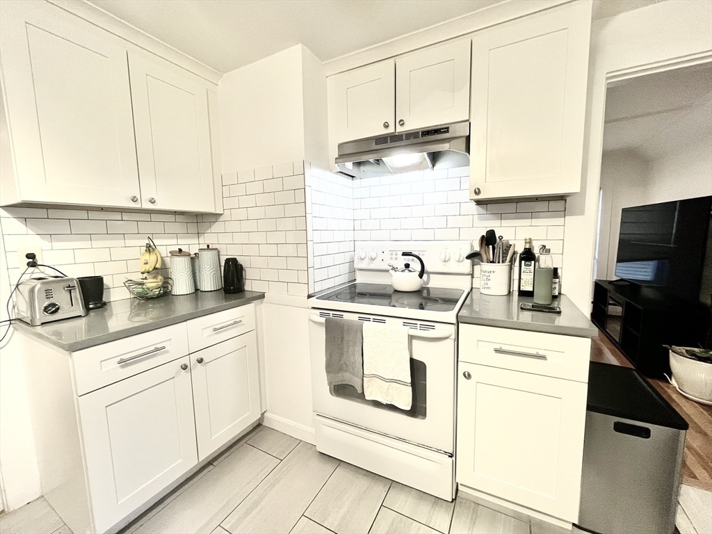 10-12 Edith Avenue, Unit 3 Everett, MA 02149 - Photo 3 of 21 a kitchen with appliances a sink and cabinets