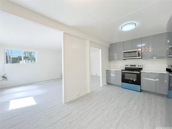 a kitchen with granite countertop a refrigerator and a stove