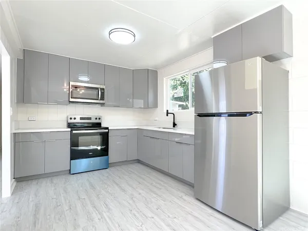 a kitchen with a refrigerator sink and microwave