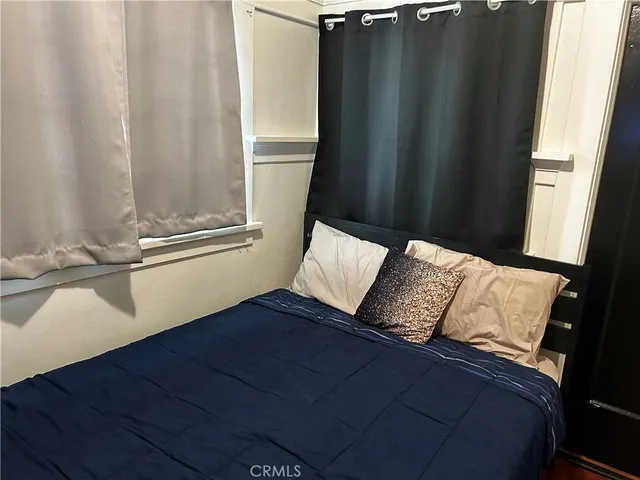 a view of bed and wooden floor