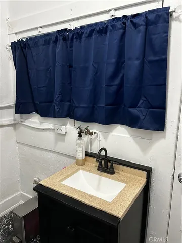 a bathroom with a sink vanity and toilet