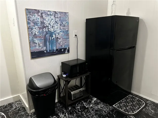a kitchen with a refrigerator and a stove