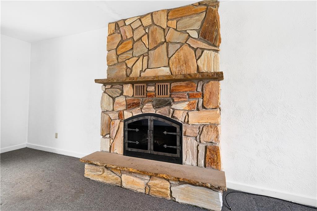1008 Schweitzer Road McKeesport, PA 15135 - Photo 14 of 43 a living room with a fireplace and a wooden floor