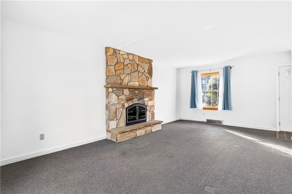 1008 Schweitzer Road McKeesport, PA 15135 - Photo 15 of 43 an empty room with a fireplace and window