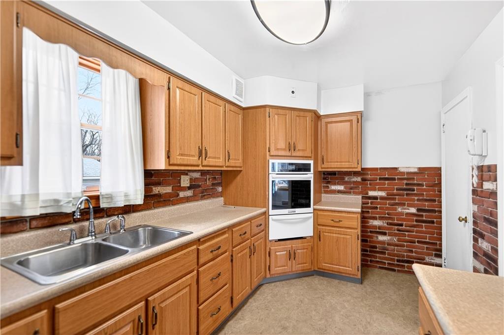 1008 Schweitzer Road McKeesport, PA 15135 - Photo 24 of 43 a kitchen with stainless steel appliances a sink a stove and a refrigerator