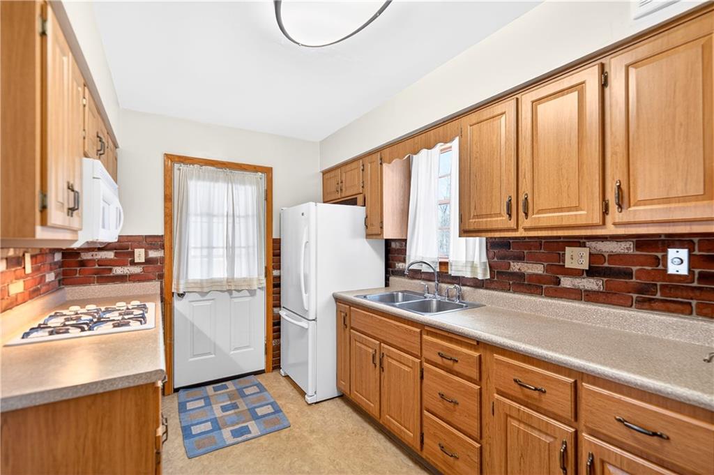 1008 Schweitzer Road McKeesport, PA 15135 - Photo 25 of 43 a kitchen with stainless steel appliances granite countertop a refrigerator sink and cabinets