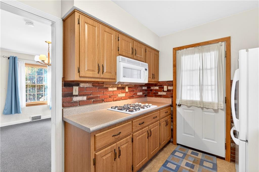 1008 Schweitzer Road McKeesport, PA 15135 - Photo 26 of 43 a kitchen with a stove a sink and a refrigerator