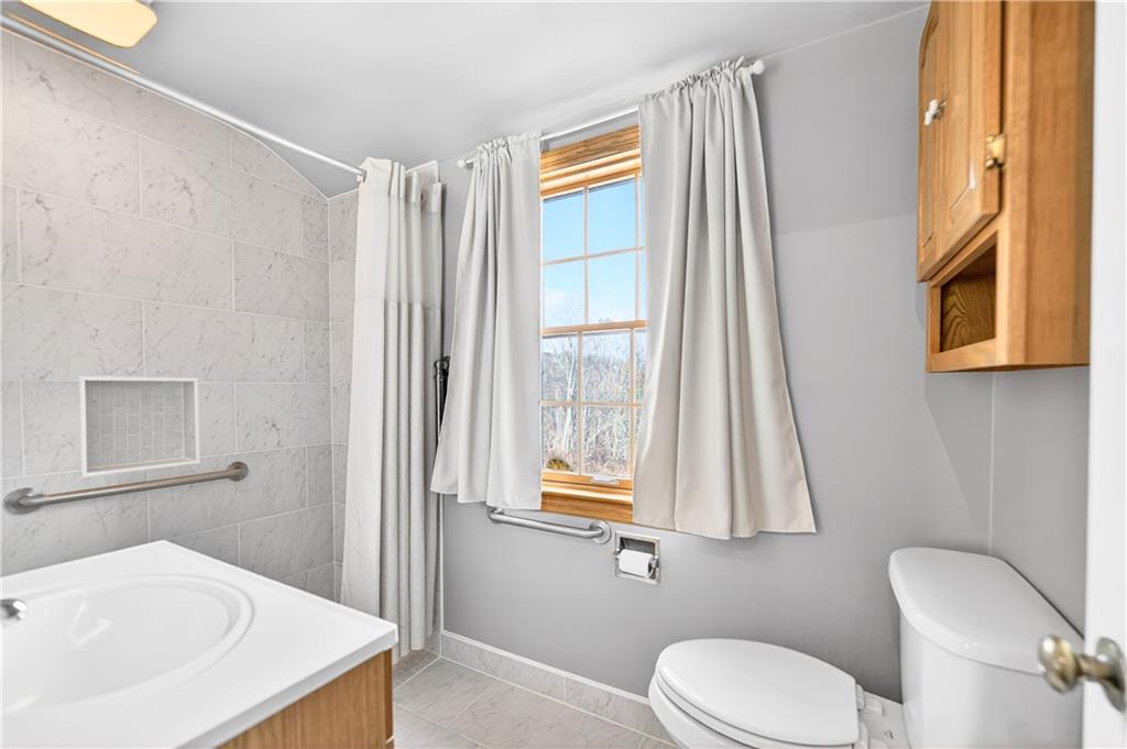 1008 Schweitzer Road McKeesport, PA 15135 - Photo 32 of 43 a bathroom with a sink a toilet and mirror
