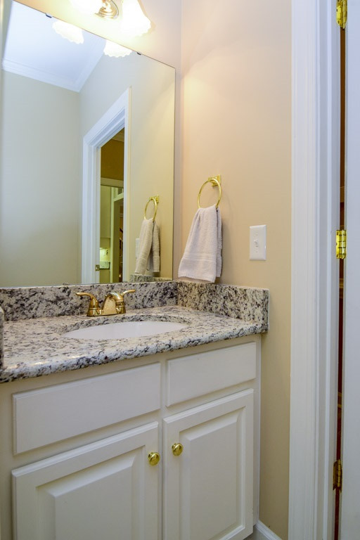 4600 Salem Ridge Road Holly Springs, NC 27540 - Photo 12 of 25 First floor full bathroom has a shower and more of those beautiful granite counter tops! First Floor Full Bathroom