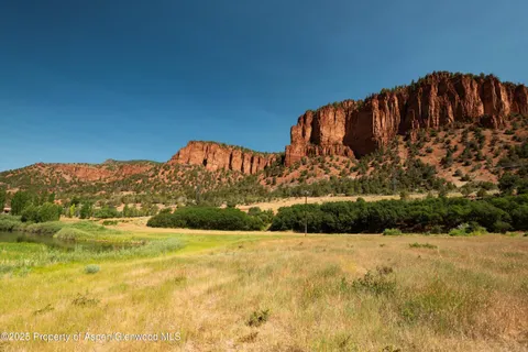 a view of a yard with wooden fence