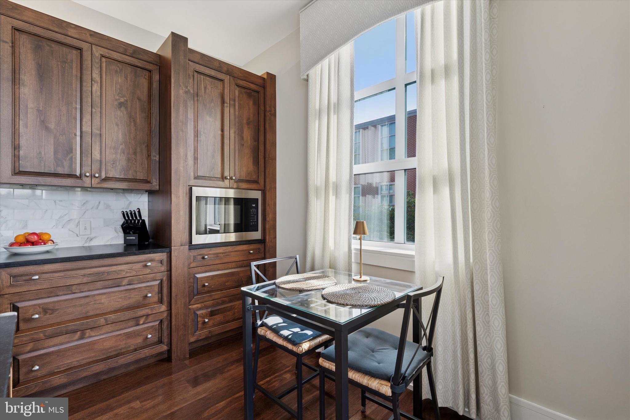 125 Iron Works Way Wayne, PA 19087 - Photo 11 of 32 a kitchen with a wooden table and chairs