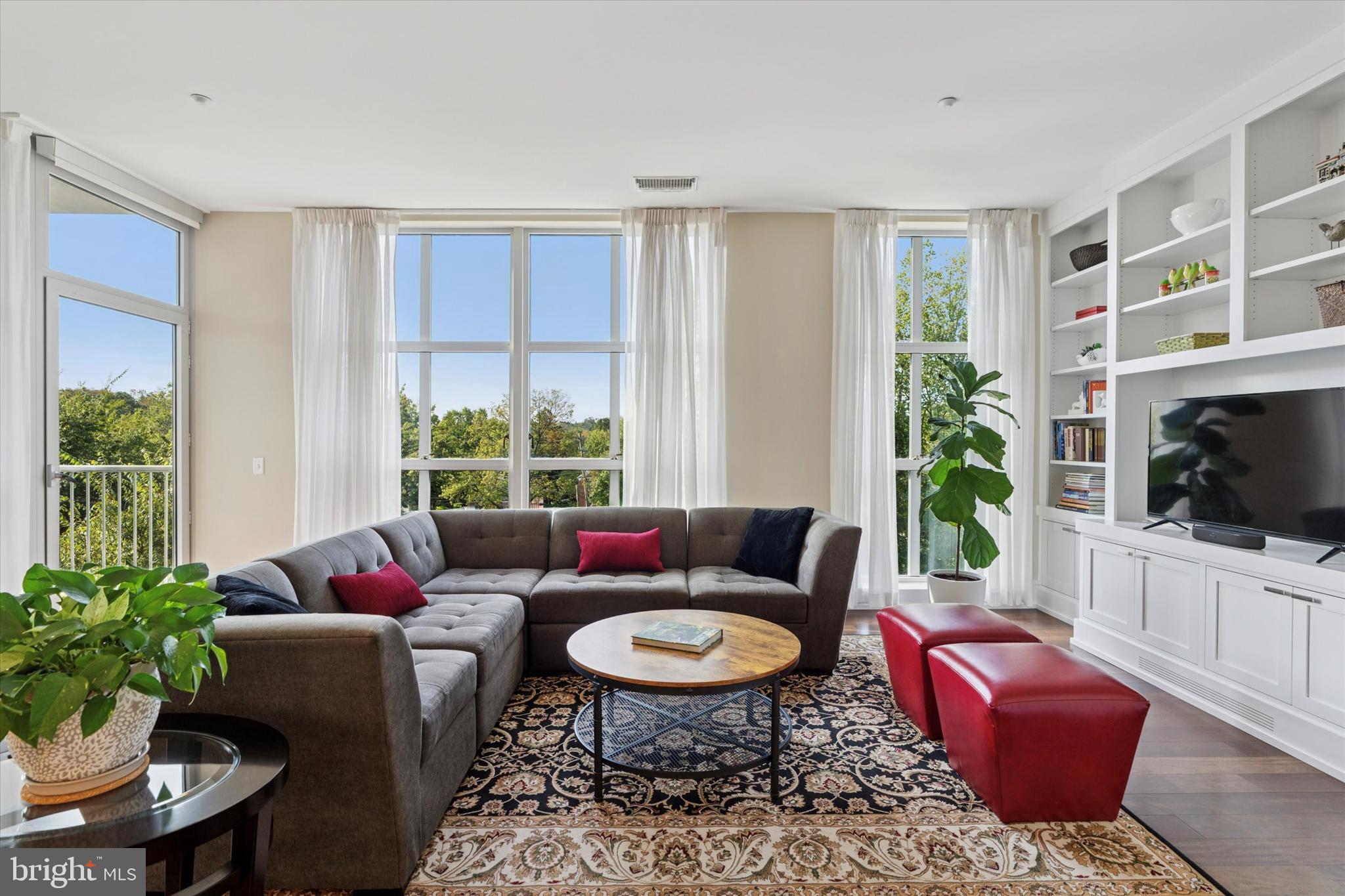 125 Iron Works Way Wayne, PA 19087 - Photo 17 of 32 a living room with furniture a flat screen tv and a large window