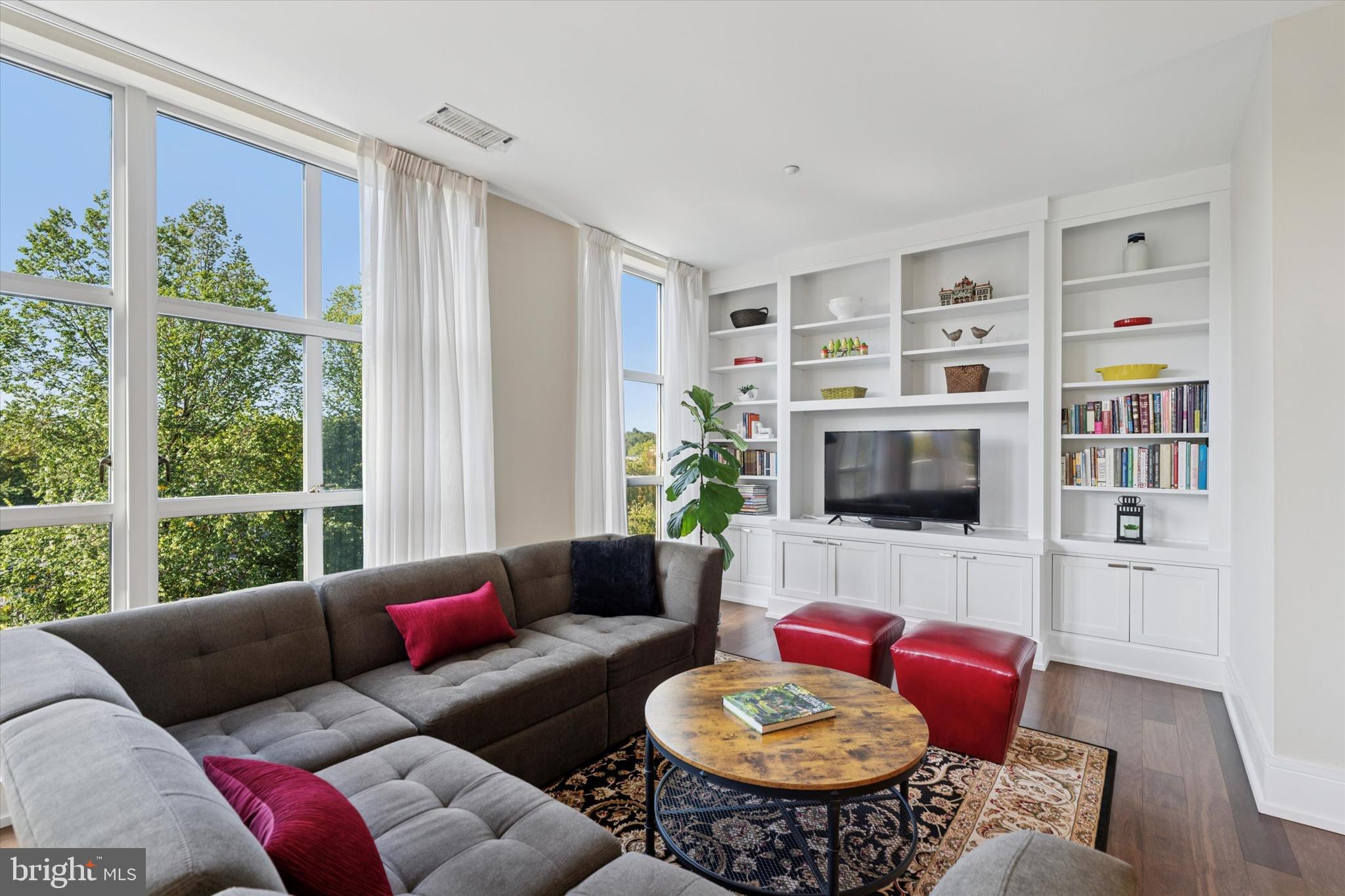125 Iron Works Way Wayne, PA 19087 - Photo 18 of 32 a living room with furniture a flat screen tv and a large window