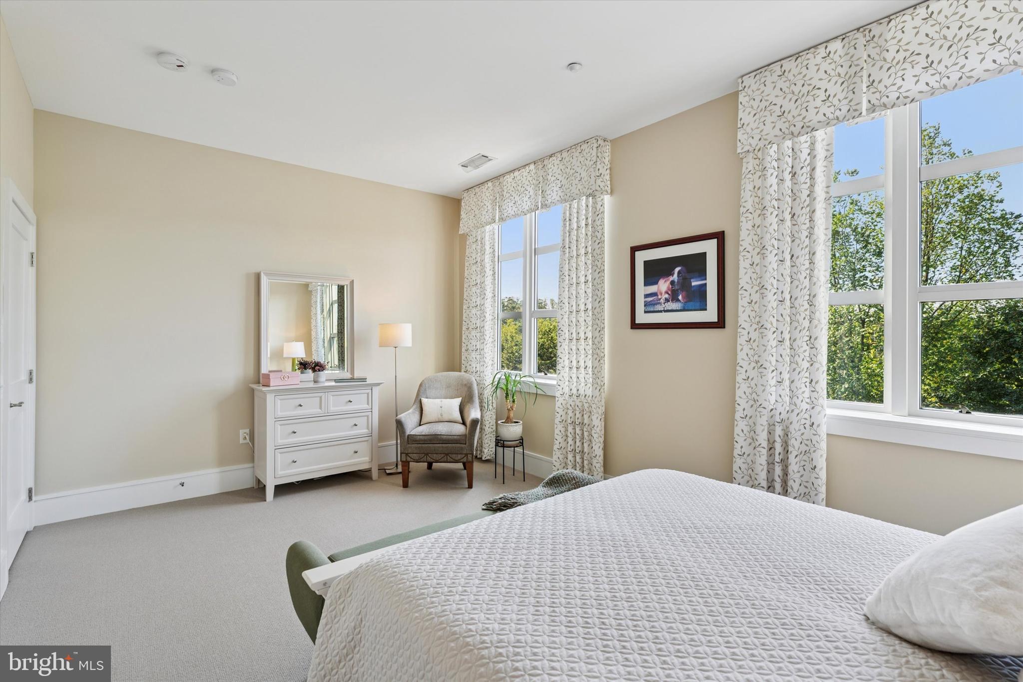 125 Iron Works Way Wayne, PA 19087 - Photo 22 of 32 a bedroom with a bed couch and three windows