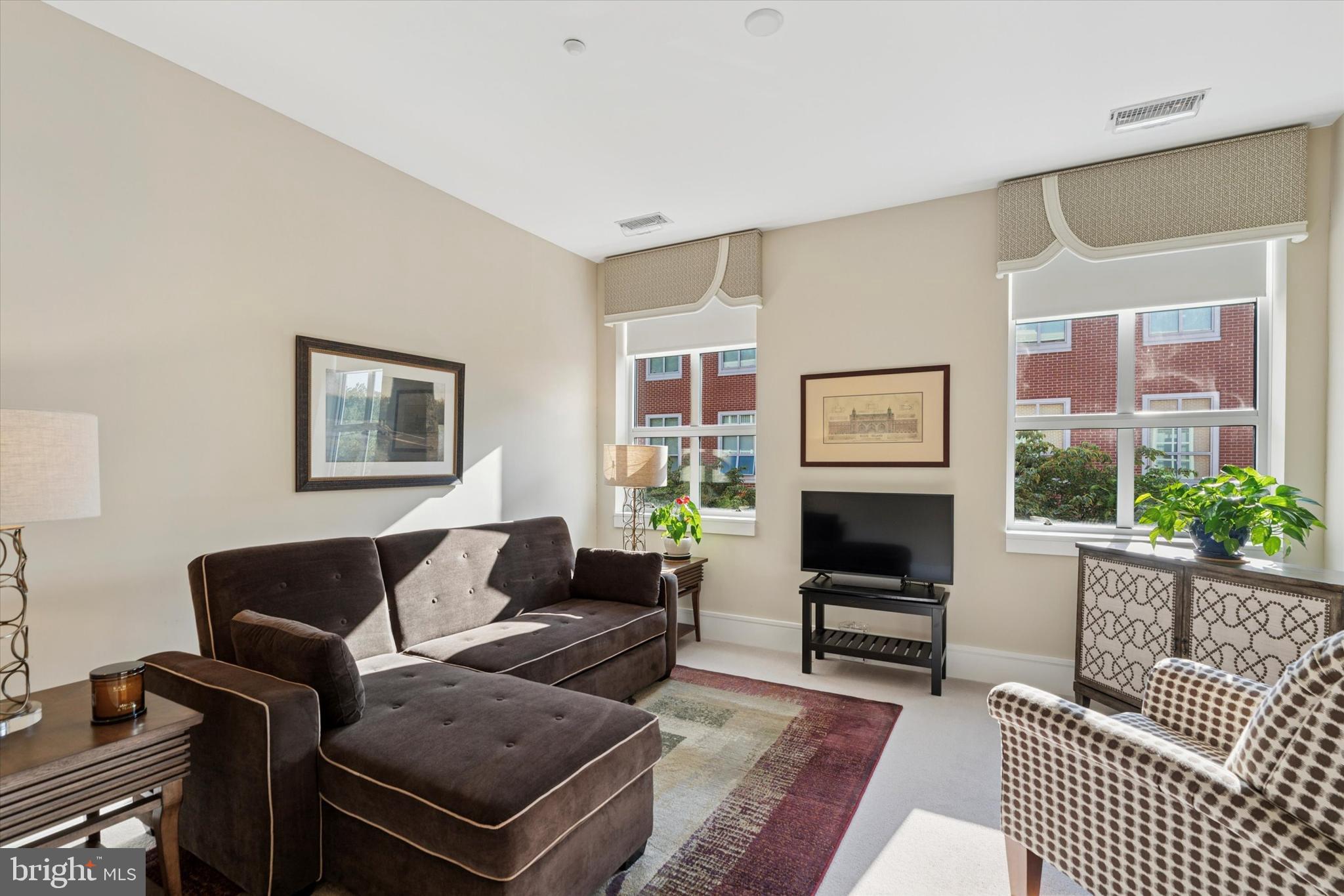 125 Iron Works Way Wayne, PA 19087 - Photo 26 of 32 a living room with furniture a flat screen tv and a fireplace