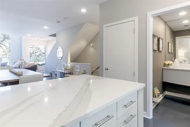 a large bedroom with a bed and a view of living room