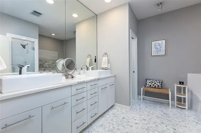 a bathroom with a tub a toilet and a shower