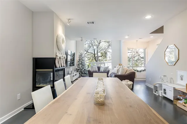a living room with furniture a rug and a large window