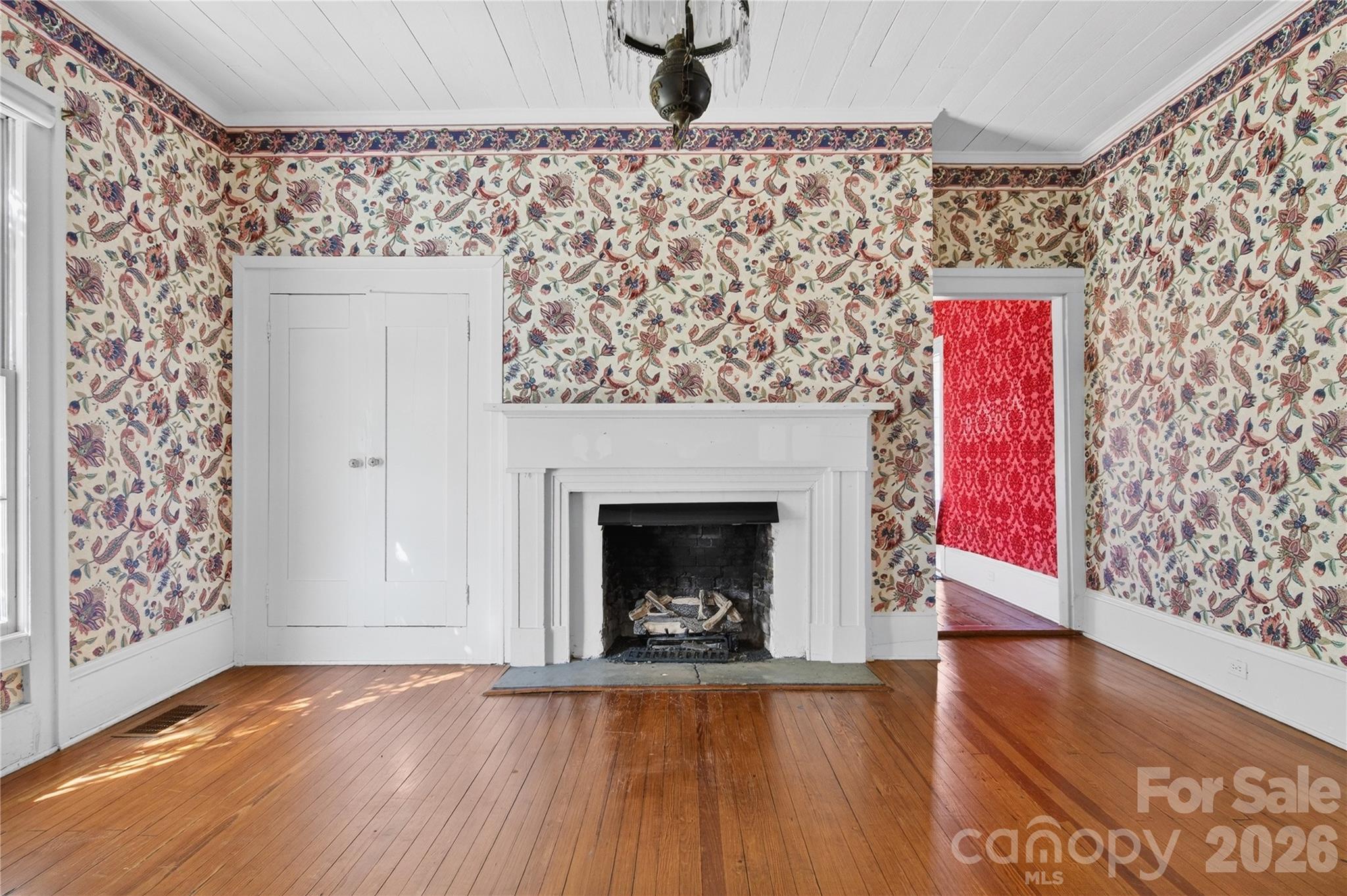 11124 Eastfield Road Huntersville, NC 28078 - Photo 15 of 42 a living room with a fireplace and a wooden floor