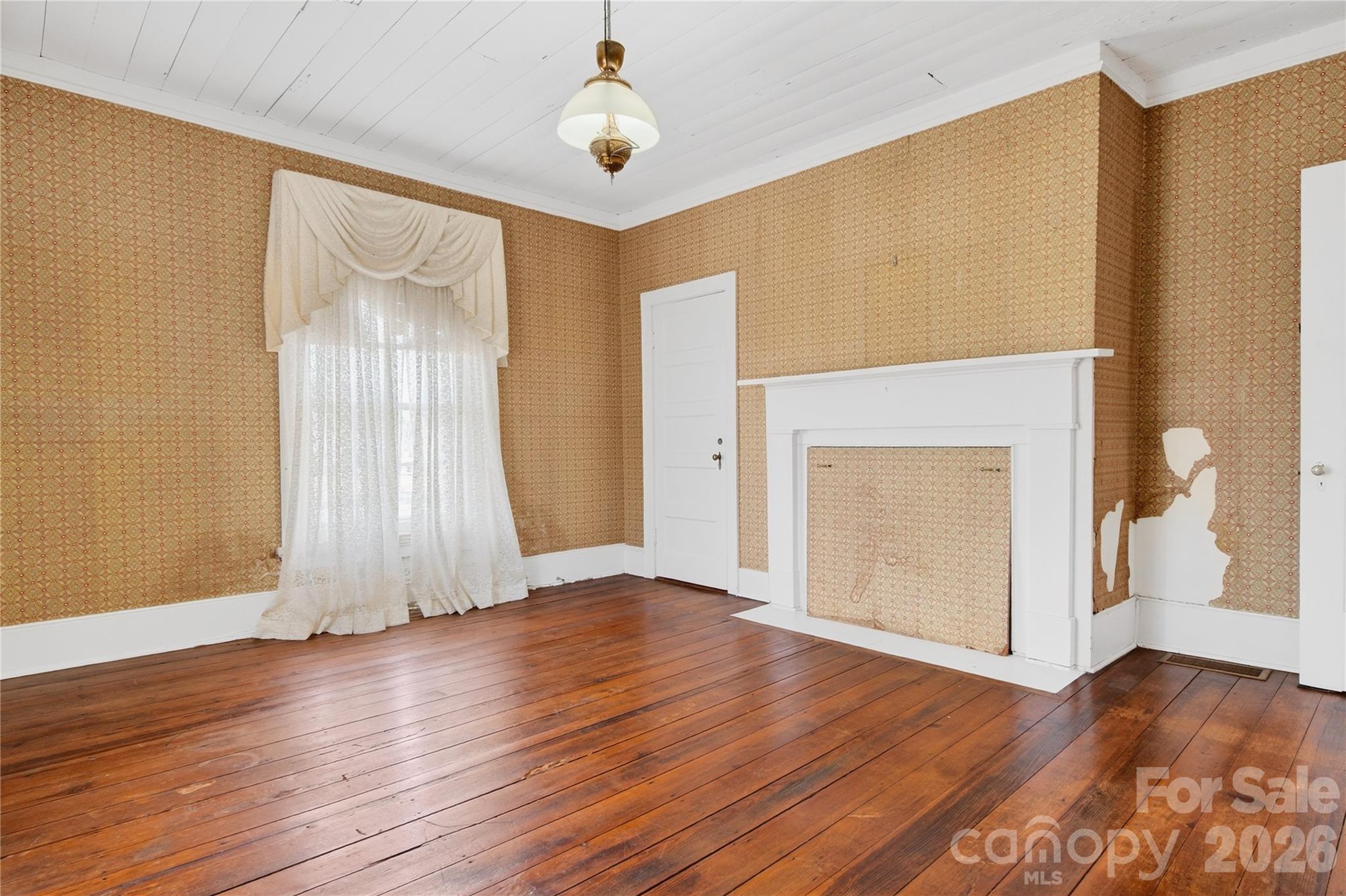 11124 Eastfield Road Huntersville, NC 28078 - Photo 27 of 42 an empty room with wooden floor and a window