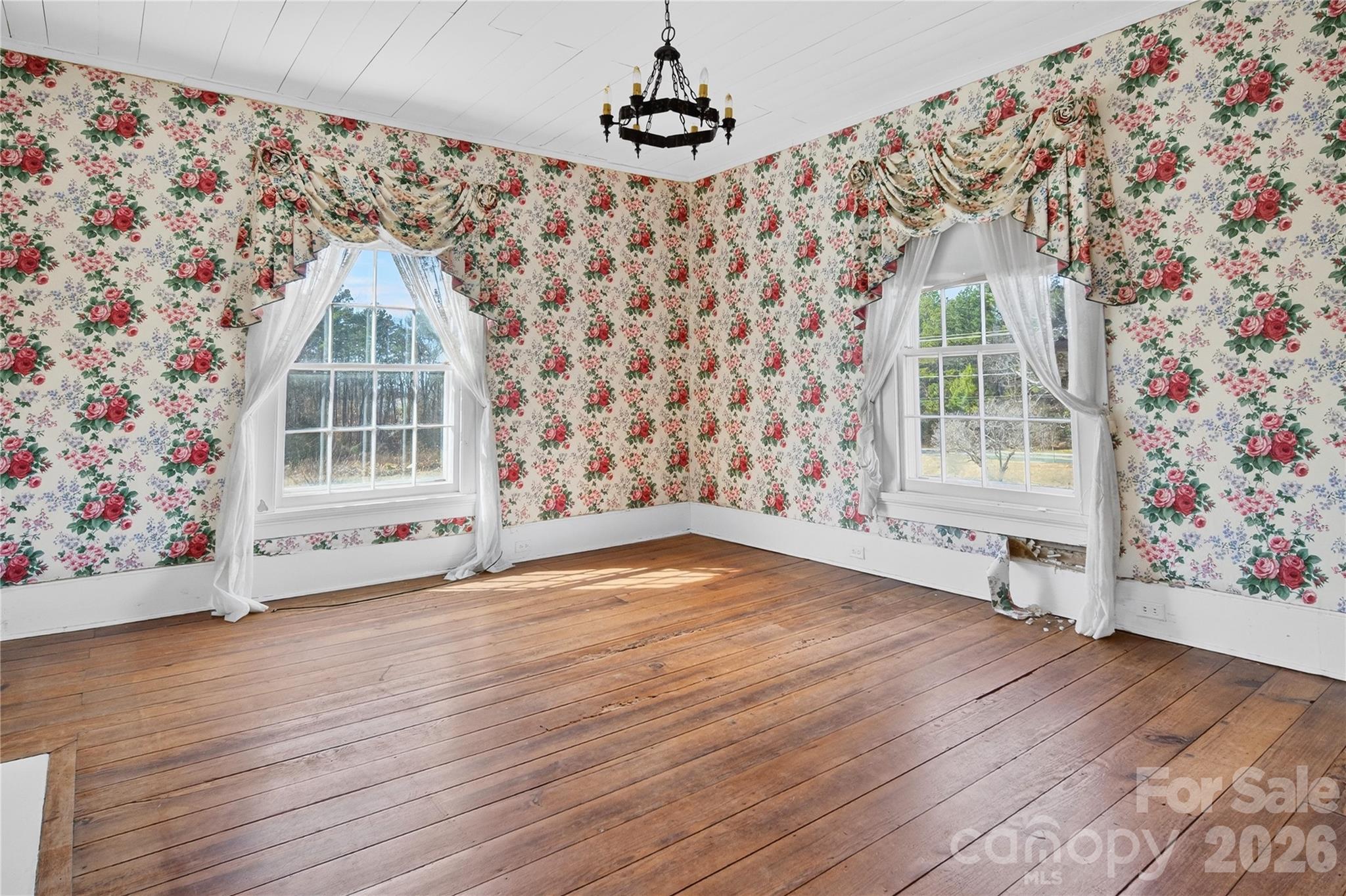 11124 Eastfield Road Huntersville, NC 28078 - Photo 28 of 42 an empty room with wooden floor and windows