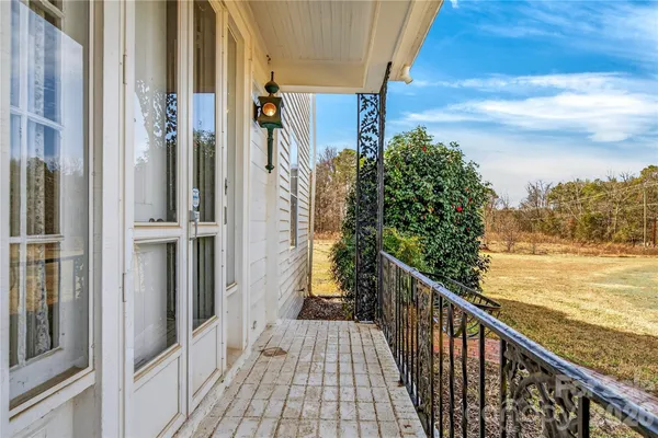 a view of a balcony with wooden floor and fence
