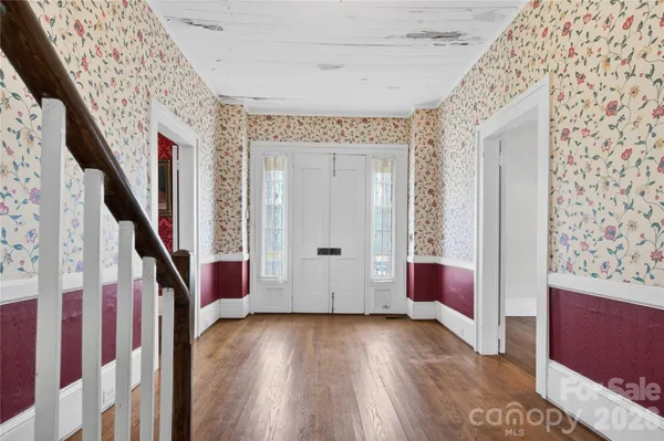 a view of an entryway with wooden floor and stairs
