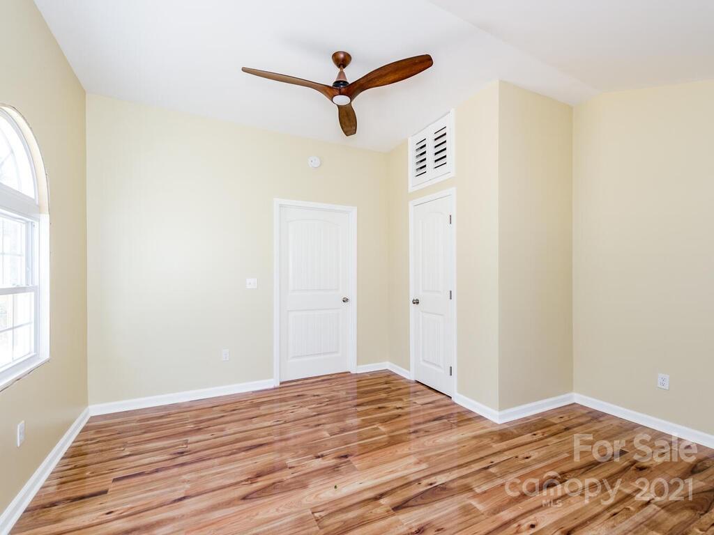 668 Pace Road Hendersonville, NC 28792 - Photo 22 of 37 a view of a livingroom with wooden floor and a ceiling fan