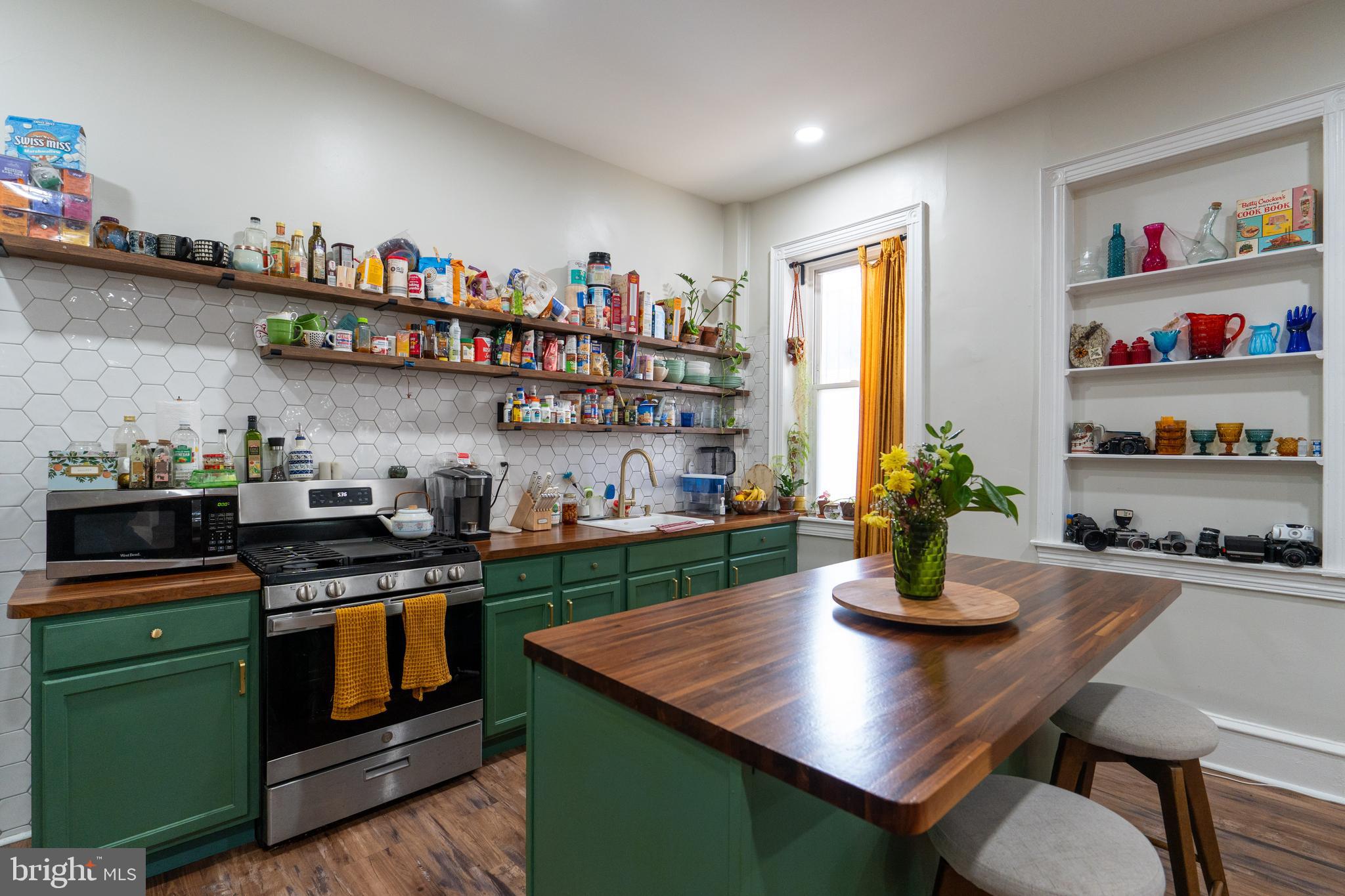 1900 South 18th Street Philadelphia, PA 19145 - Photo 9 of 15 a kitchen with a stove a sink and a kitchen island