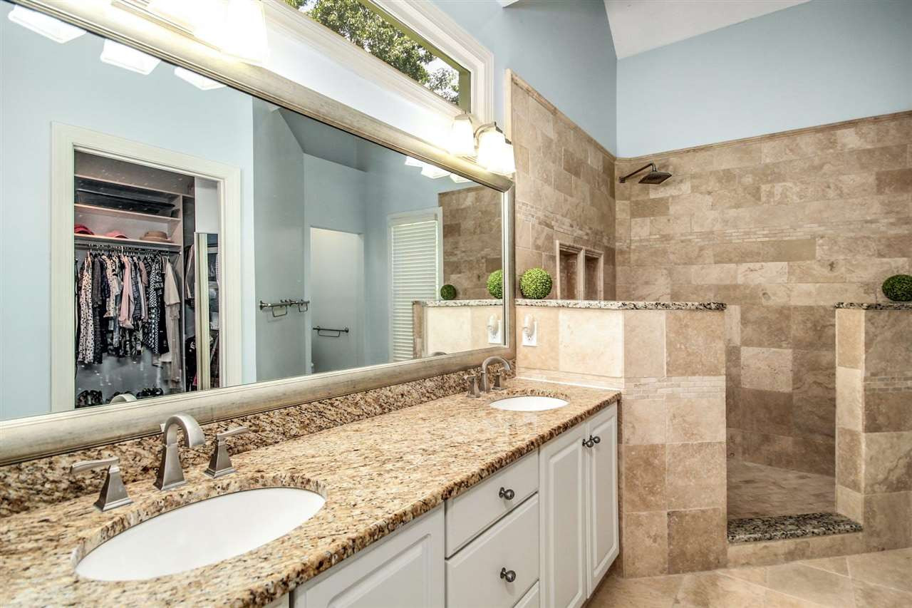 4812 Salem Ridge Road Holly Springs, NC 27540 - Photo 19 of 30 Dual vanities, travertine tile, custom walk-in closet with built-ins! Updated Master Bath