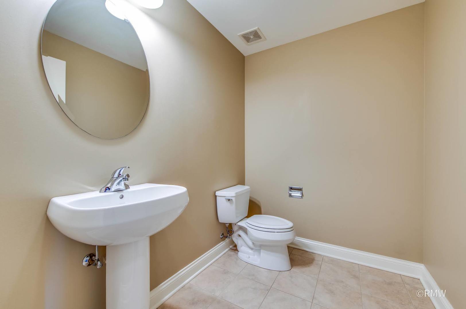 2 Itasca Place, Unit 419 Addison, IL 60143 - Photo 14 of 21 a bathroom with a sink and a mirror