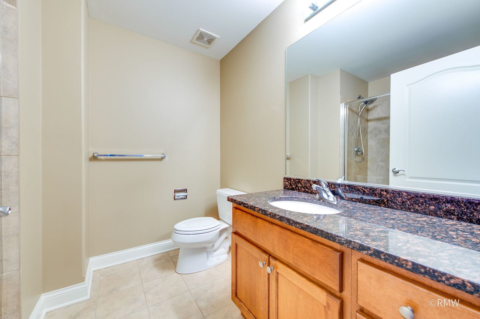 2 Itasca Place, Unit 419 Addison, IL 60143 - Photo 15 of 21 a bathroom with a granite countertop sink a toilet and a mirror
