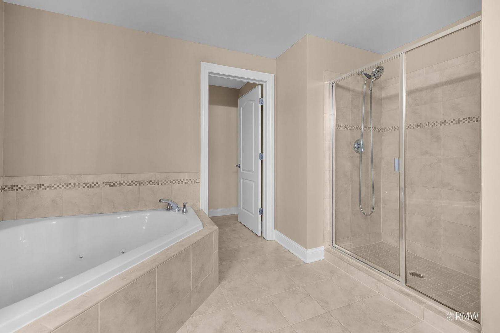 2 Itasca Place, Unit 419 Addison, IL 60143 - Photo 18 of 21 a bathroom with a bathtub and shower