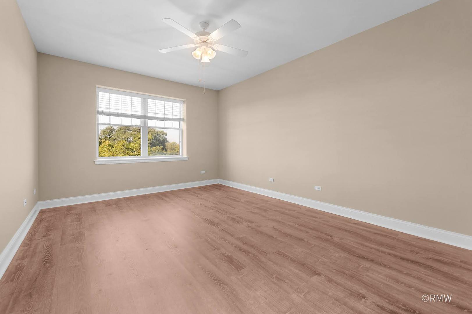 2 Itasca Place, Unit 419 Addison, IL 60143 - Photo 19 of 21 an empty room with wooden floor and windows